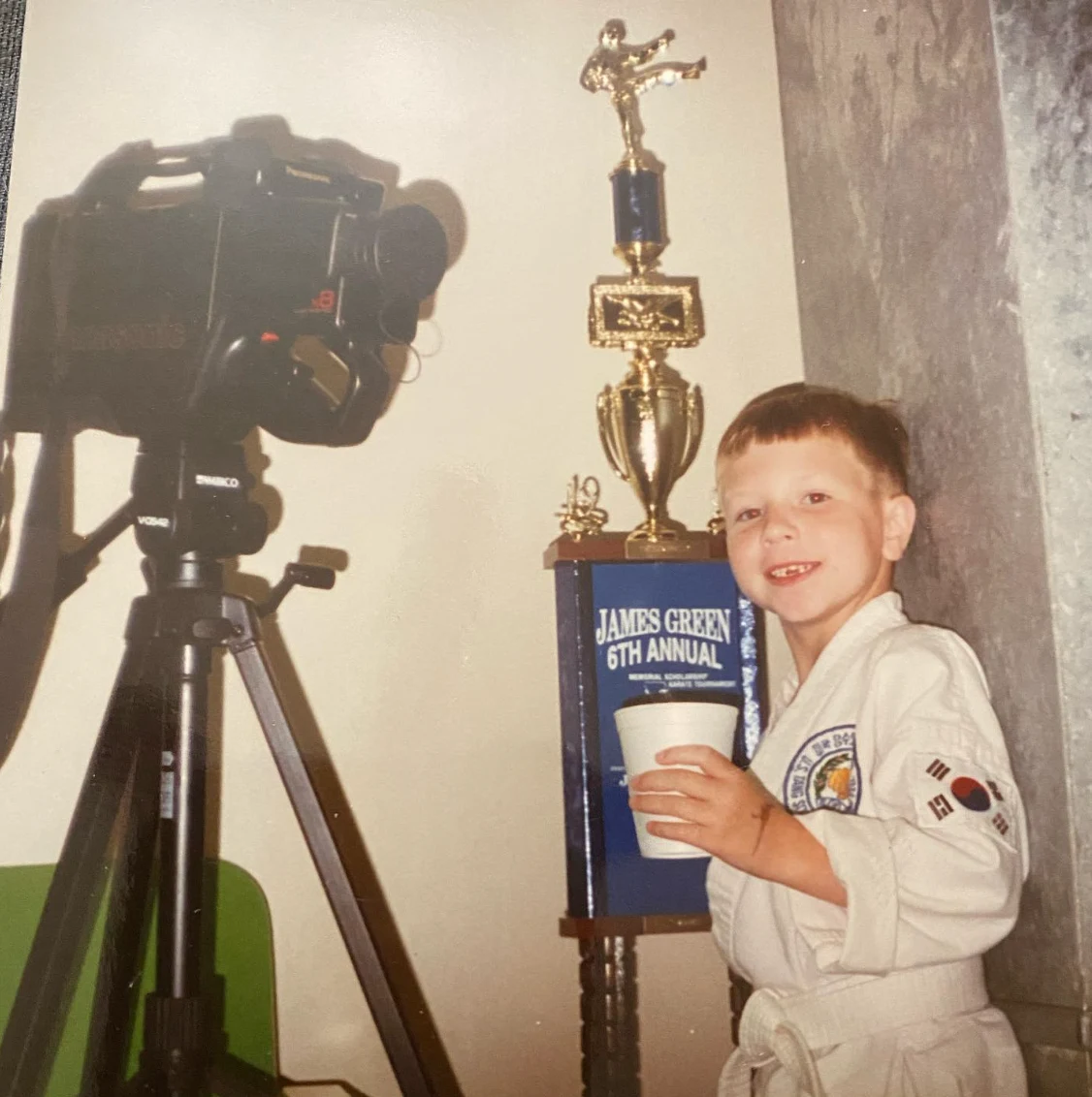 Patrick with a Taekwondo trophy as a child